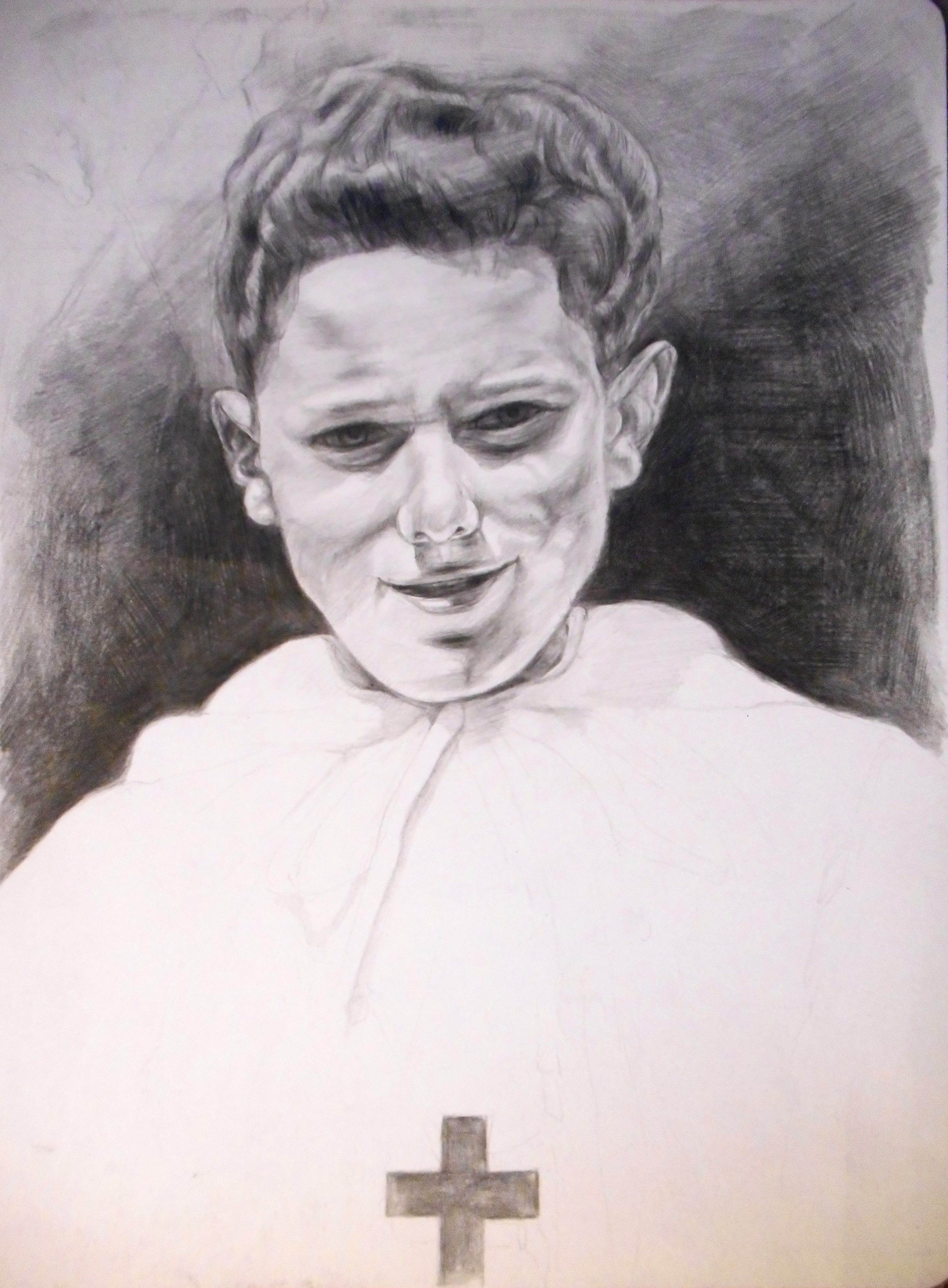 Smiling altar boy with a cross on his chest.